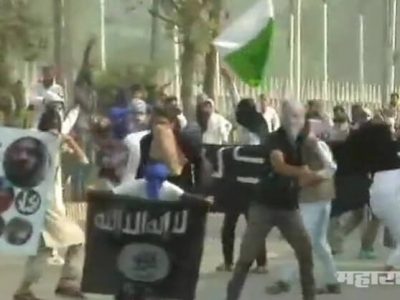 Youngster holds the flag of Pakistan and ISIS